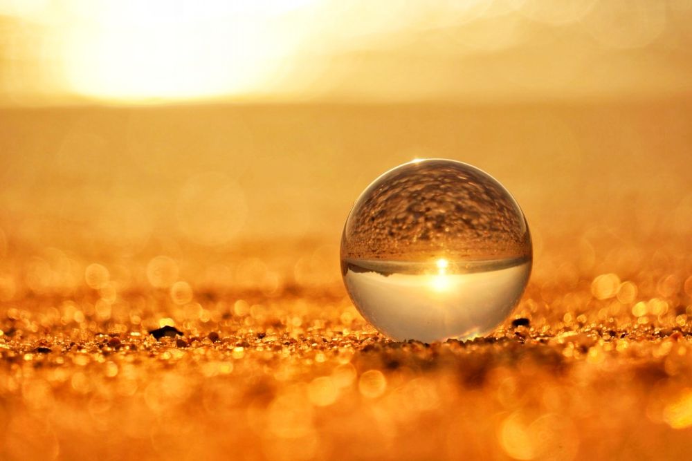 夕日の砂浜とガラス玉